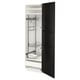Black and white METOD closet with multiple storage shelves and hanging rod.