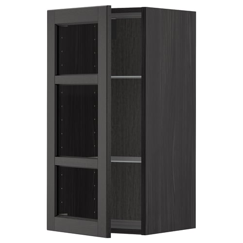 Black stained wooden kitchen cabinet with glass doors and shelves.