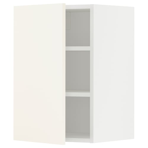 A white METOD wall cabinet from ikea with three shelves. Its rectangular and has a simple, modern design.