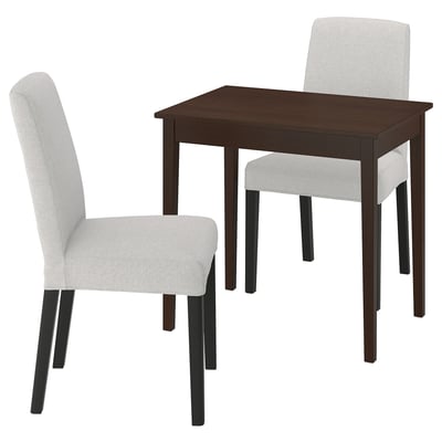Brown dining table with two grey chairs. Table has chamfered legs, chairs have fabric seats and wooden legs.