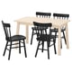 A light wood dining table with four black chairs, capturing a minimalist scandinavian design.