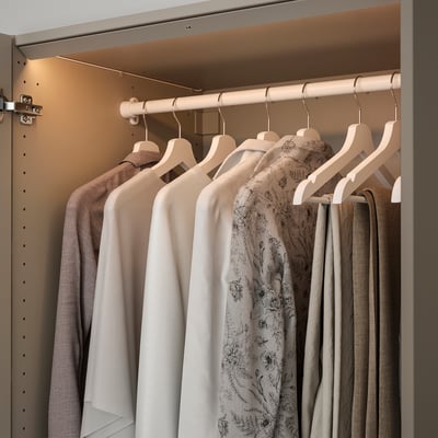 A wardrobe with led light strips illuminating clothes hangers inside, showcasing a modern, energy-efficient lighting solution.