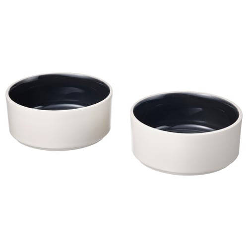 Two white porcelain bowls with dark interiors, simple and minimalist design.