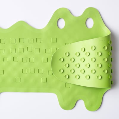 A lime green bath mat with suction cups, designed to prevent slipping and can hang for drying.