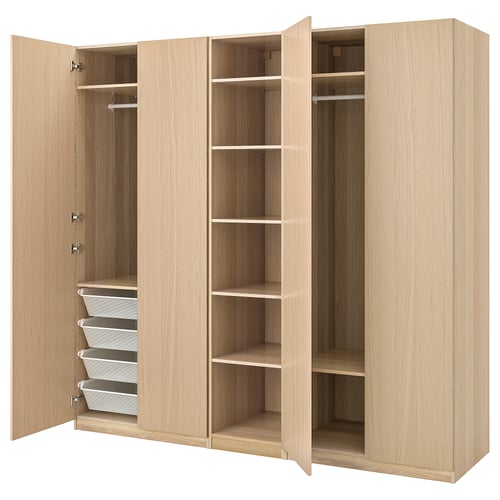 Light wood PAX wardrobe with shelves, hanging rails, and mesh baskets.