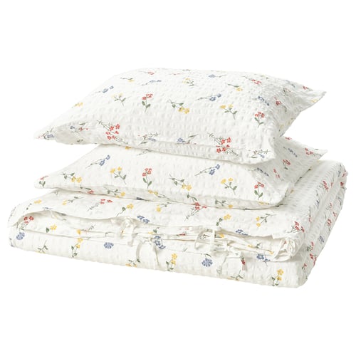 A white PILDVÄRGMAL bedding set with colourful floral patterns, seersucker texture, cotton/viscose material.