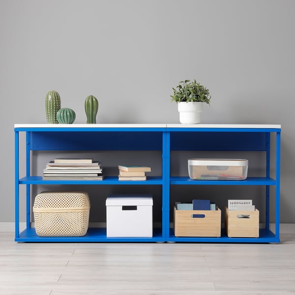Blue storage unit with shelves, holding books, boxes, and plants, suitable for compact spaces.