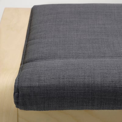 Closup view of thick, grey POÄNG cushion on wooden surface, showcasing its durable, comfortable fabric.
