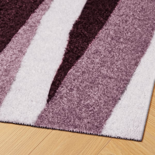 A plush, textured doormat with purple and white stripes. High-quality materials for durability and dirt absorption, enhancing any entryway.