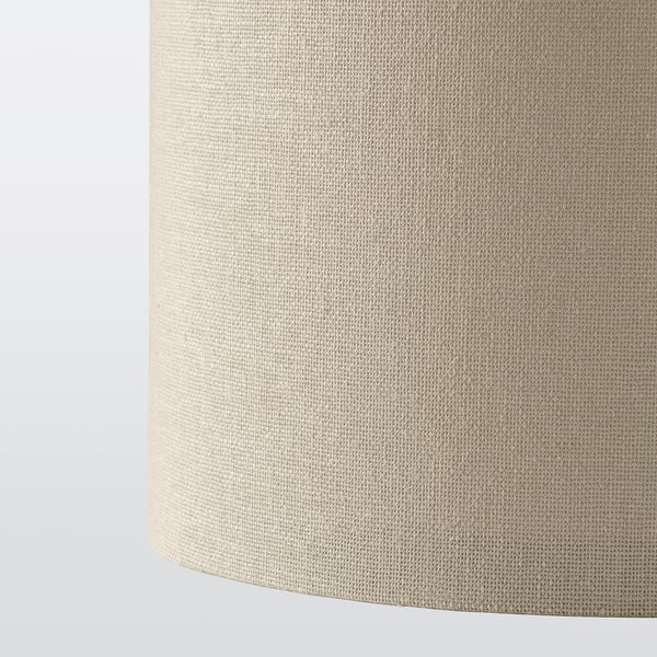 Close-up of a beige woven lampshade, showcasing its textured material and quality.