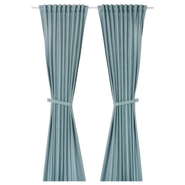 Two light grey-blue RITVA curtains, made of cotton, hanging straight with tie-backs.