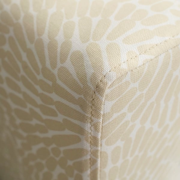 Close-up of neatly upholstered sofa corner, showcasing quality stitching and fabric texture.