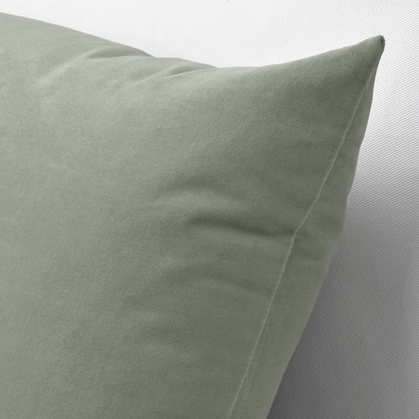 Close-up of plush, velvet cushion showing rich texture and neat stitching.