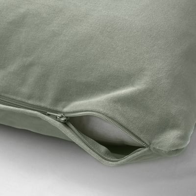 Light green cushion cover with zip. Made of soft cotton velvet. Zips open for easy washing.