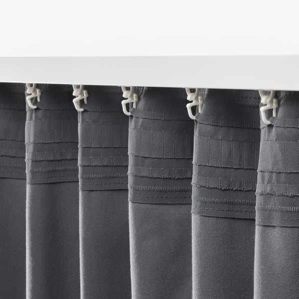 Grey velvet curtains hang with hooks, blocking light and providing insulation.