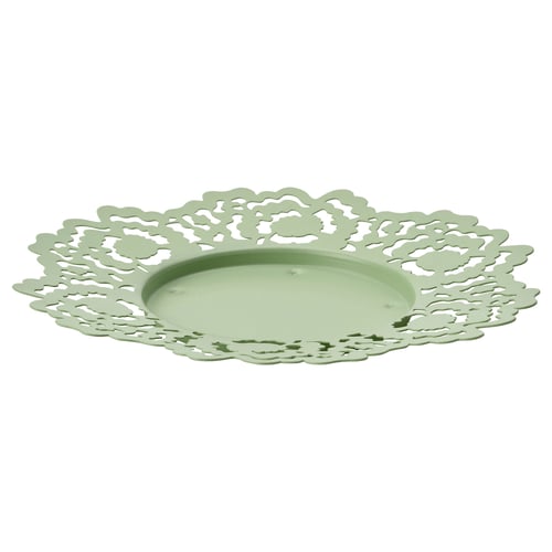 A round green metal candle dish with a delicate floral cutout design.