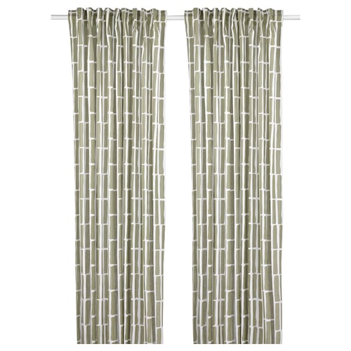 Green curtains with geometric patterns hang side by side.