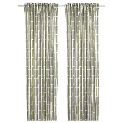 Green curtains with geometric patterns hang side by side.