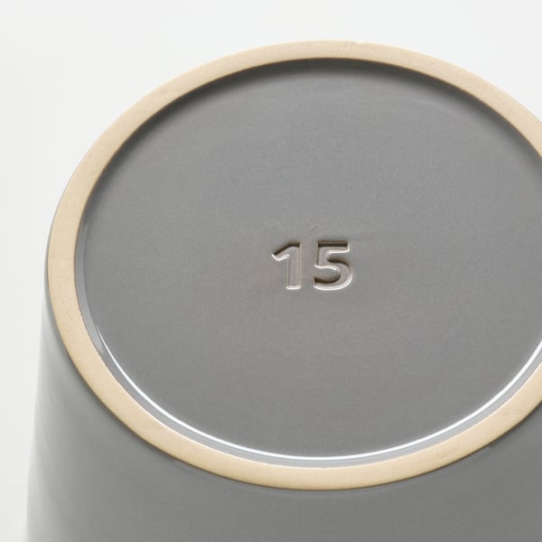 Cylindrical grey planter with gold edge, showing 15 on base, indicating quality and design.