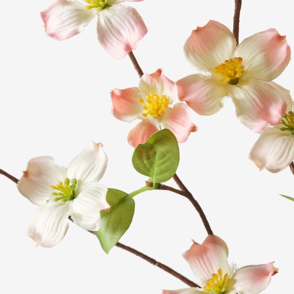 Beautiful artificial flowers with delicate pink and white petals, green leaves, and realistic yellow centres.