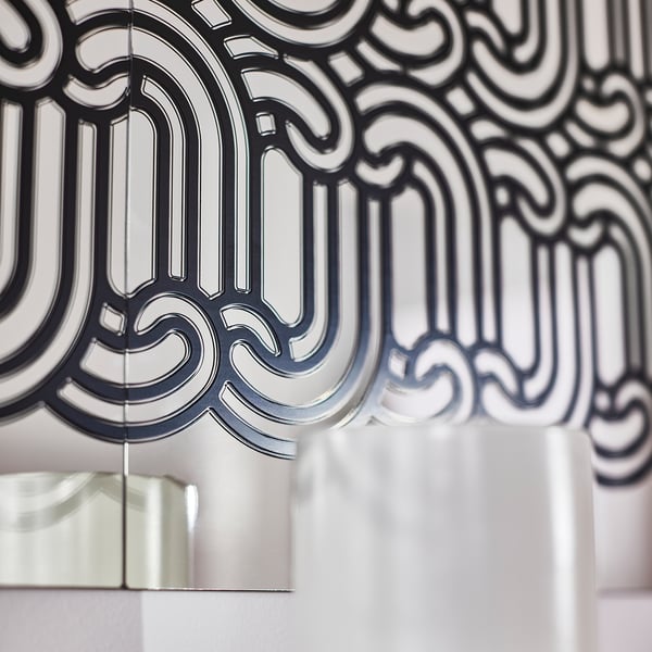 Intricate patterned mirror with flowing design, high-quality finish, reflective surface.