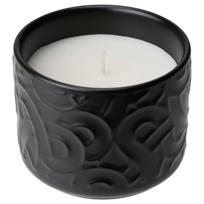 Black ceramic candle with textured design. Holds unscented white candle. Ideal for home decor.