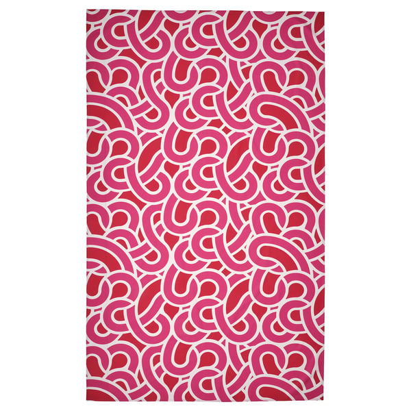 A bright pink rectangular tablecloth with rectangular white patterns. Made of 100% cotton, it a playful, vibrant design.