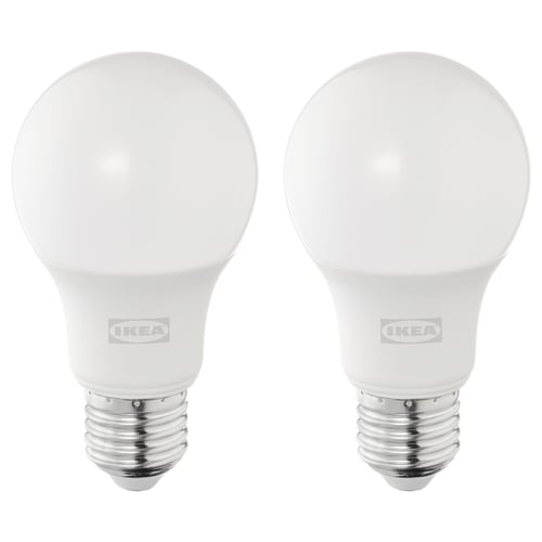 Two ikea led bulbs, white, round shape, silver base, stand upright, brand visible.