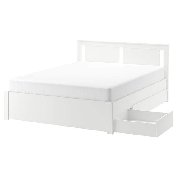 White SONGESAND bed, modern design, storage drawers, high legs, clean edges.
