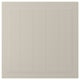 This image shows a beige STENSUND cabinet door with vertical grooves and a rectangular design.