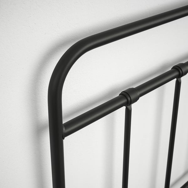 Black metal bed frame with curved headboard, showcasing sturdy and sleek design, ensuring durability and modern aesthetic.