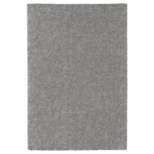 A grey rectangular STOENSE rug with a soft, textured surface, perfect for adding comfort and style to rooms.