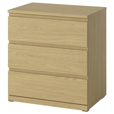 A STORKLINTA wooden chest in oak colour with three drawers, featuring a sleek and modern design.