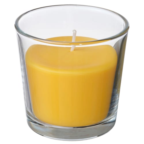 Bright yellow scented candle in clear glass cup, cylindrical shape, fresh mimosa scent.