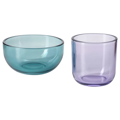 Two glass items, one bowl-shaped in teal and one cup-shaped in lavender, displayed side by side.