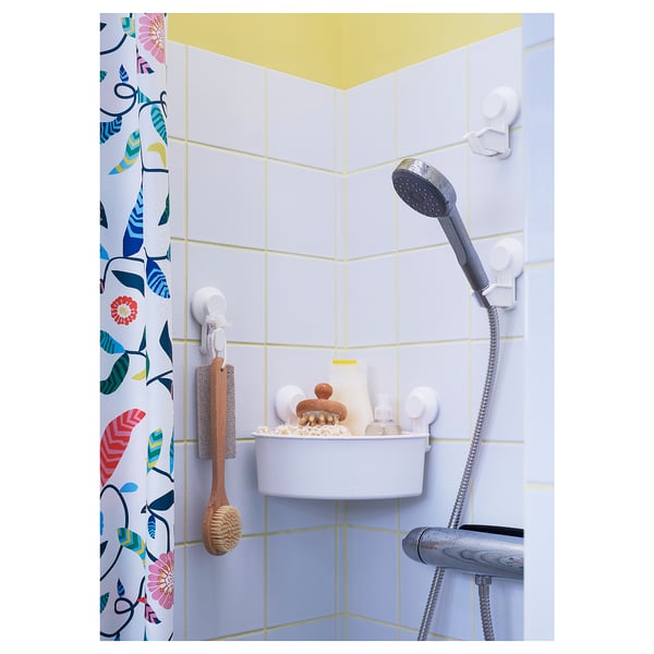 Shower with TISKEN white hooks, holding brushes and bottles on blue-tiled wall, grey handshower.