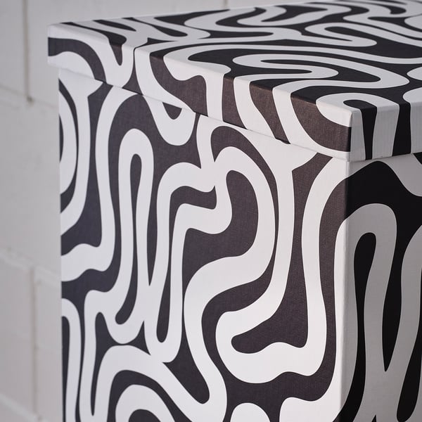 Black & white TJENA storage box with wavy pattern, made of recycled paperboard.