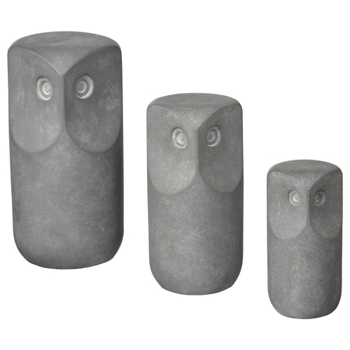 Three grey concrete owl ornaments in varying sizes, standing upright with large eyes, suitable for indoor/outdoor decor.