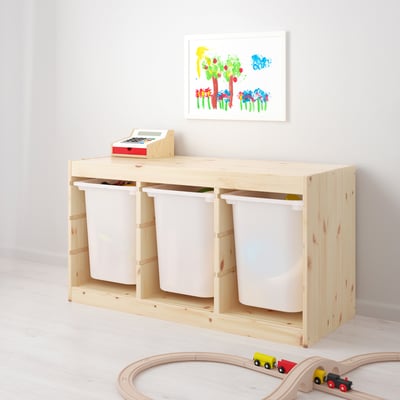 Wooden storage unit with three white bins, perfect for toy organisation. Ideal for children to reach and arrange their toys easily.
