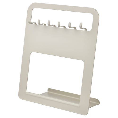 A beige UPPFYLLD kitchen utensil holder. Its rectangular with hooks for 6 items and a back slot for a board or tablet. Made of powder-coated steel.