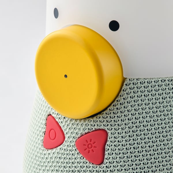 Bright yellow top speaker, soft red shapes, textured surface. Kids speaker with playful design.