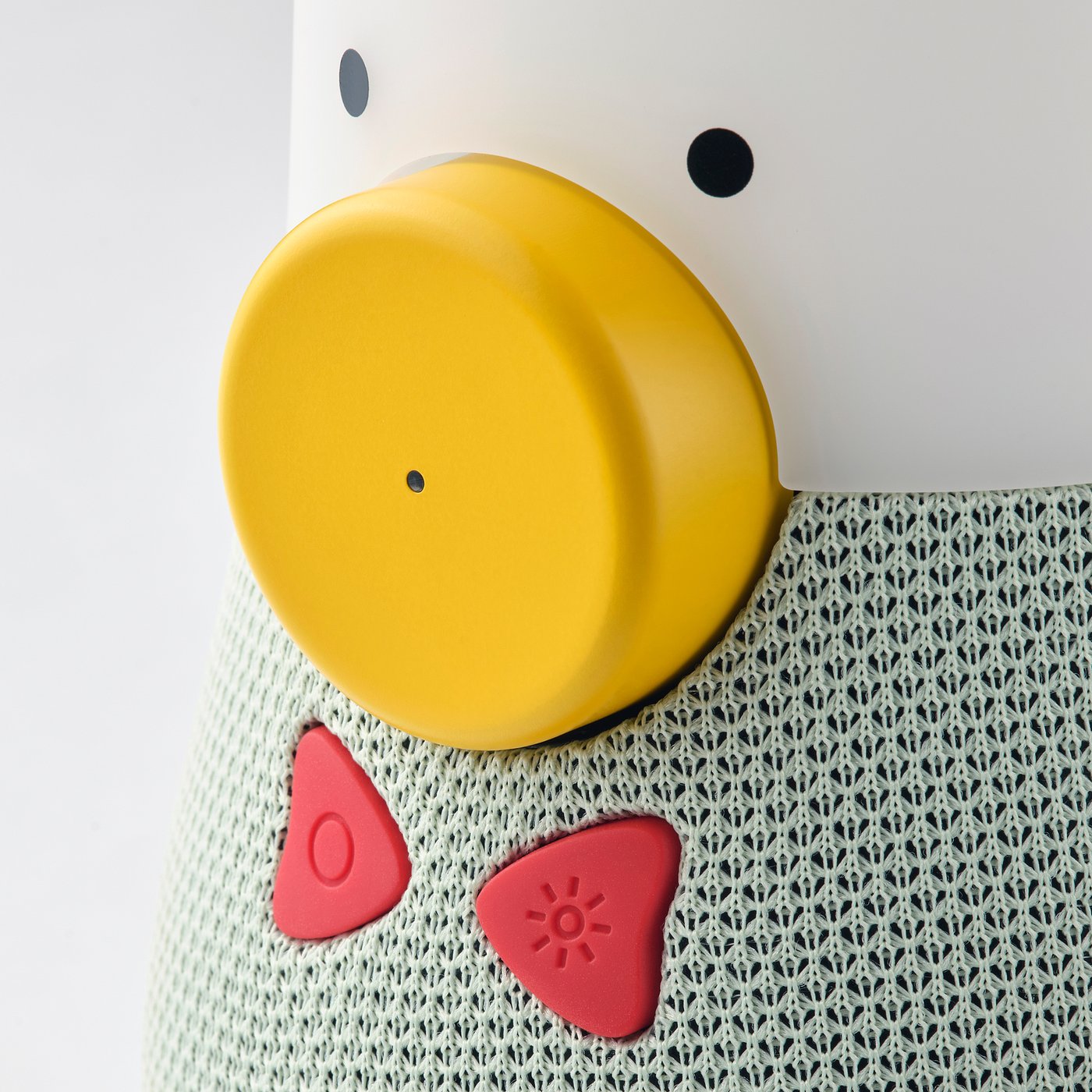 Bright yellow top speaker, soft red shapes, textured surface. Kids speaker with playful design.