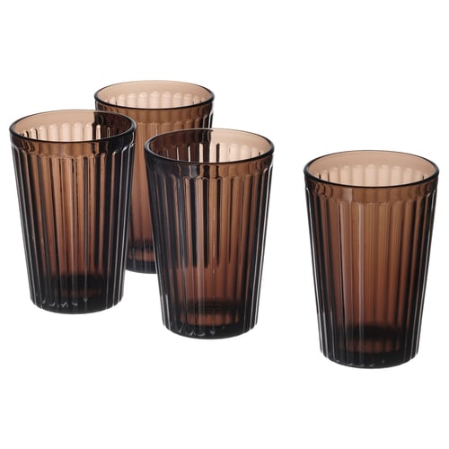 Four brown, tall, ribbed, glass cups in a row, showing detailed fluting and a refined design.