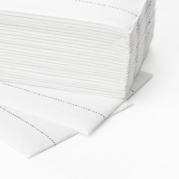 Stack of folded white napkins with blue dashed lines; neatly arranged, highly absorbent, two-ply paper.