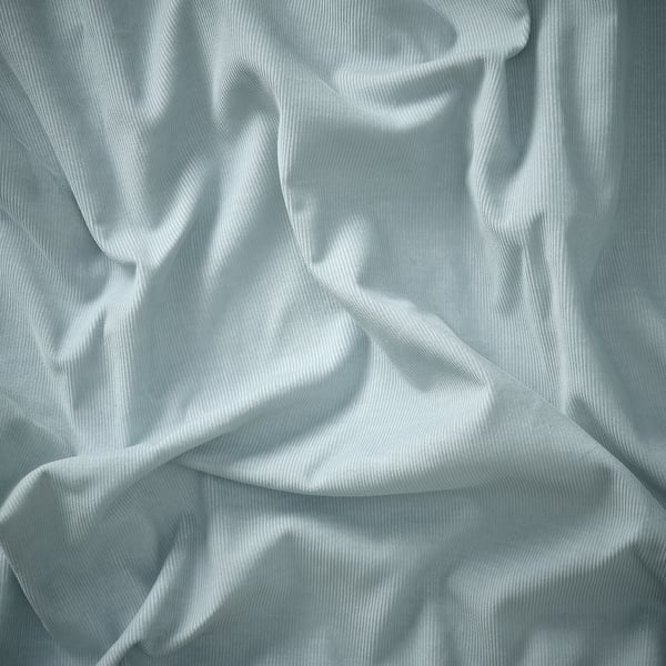 Soft, crumpled light blue fabric, likely recycled polyester and cotton blend, showcasing texture and quality.