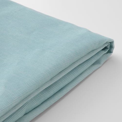 Folded light blue textile on white surface. Fabric appears soft, durable, showcasing corduroy texture.