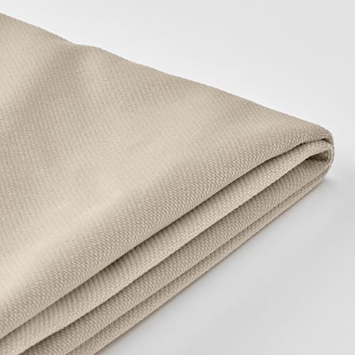 Folded beige sofa cover, smooth and textured, displayed on white background.