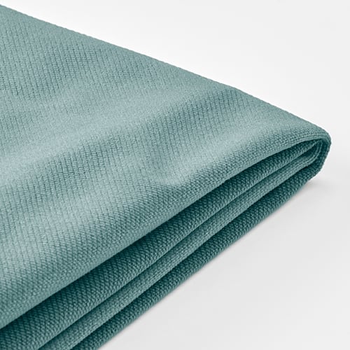 Folded teal sofa cover, smooth texture, quality fabric, clean lines.