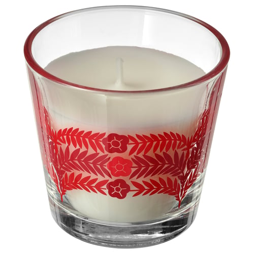 Red and clear scented candle in glass, with floral design, white wax, cylindrical shape.