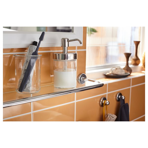 Clear glass, metal bathroom organiser with soap dispenser and toothbrush holder.